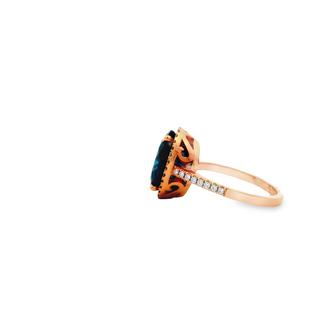 18CT COCKTAIL RING ROSE GOLD CLAW SET FEATURING NATURAL OVAL LONDON BLUE TOPAZ AND NATURAL BRILLIANT CUT DIAMONDS AND FILIGREE SETTING HAND CRAFTED BY CRICELLI